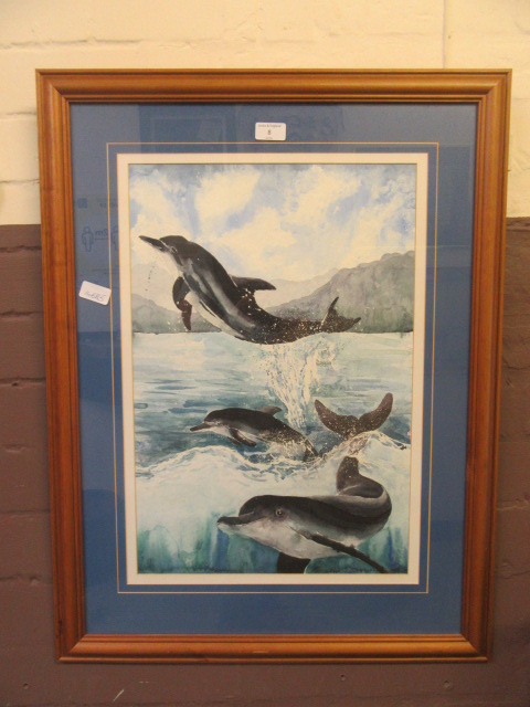 A framed and glazed watercolour of dolphins signed Kim Richardson