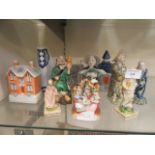 A selection of ceramic figures to include two Staffordshire cottages
