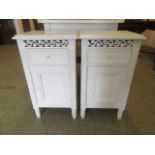 A pair of white bedside cabinets with single drawer over cupboard door