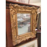An ornate gilt framed rectangular mirror
