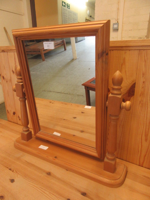 A modern pine toilet mirror
