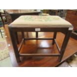 An early 20th century mahogany stool with a wool work seat