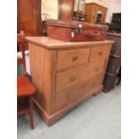 A stripped pine chest of two short and two long drawers