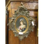 A 19th century continental painting on oval ceramic tile in elaborate frame