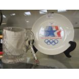 A Los Angeles 1984 Olympic Games plate together with a glass tankard containing a commemorative
