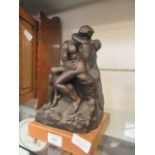 A modern resin sculpture of kissing couple