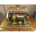 A cased Jones manual sewing machine