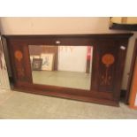 An early 20th century mahogany and marquetry bevel glass over mantle mirror