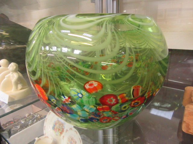 A green glass bowl with floral motif