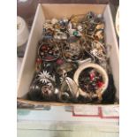 A box containing an assortment of costume jewellery