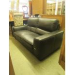 A dark brown two seater leather settee