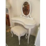 A modern cream painted kidney shaped dressing table with bevel glass mirror to back and a stool