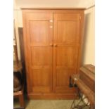 A waxed pine two door wardrobe