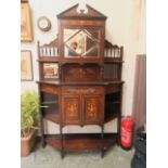 An Edwardian rosewood inlaid cabinet having a mirrored center glazed door to top with a pair of