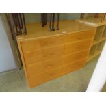 A mid-20th century oak effect bank of eight drawers