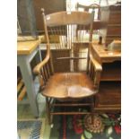 An early-20th century spindle back elbow chair