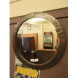 A hammered copper circular bevel glass wall mirror