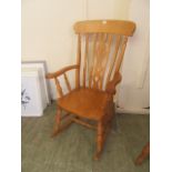 A reproduction beech rocking chair