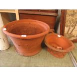 A large terracotta garden pot together with a terracotta two handled garden planter