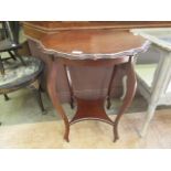 An early-20th century mahogany two tier circular occasional table