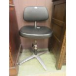 A mid-20th century industrial swivel chair