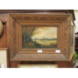 A gilt framed oil on board of country cottage scene signed bottom right