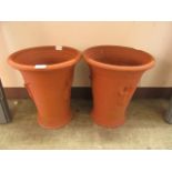 A pair of terracotta garden planters