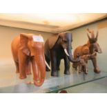 Two carved elephants along with a moulded elephant and calf