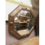 An oak framed bevel glass wall mirror