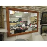 A modern pine framed wall mirror