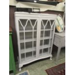 A cream painted serpentine fronted glazed display cabinet (A/F)