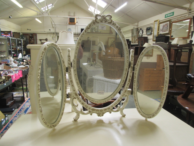 A cream and gilt painted vanity mirror