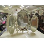 A cream and gilt painted vanity mirror