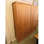 A modern pine two drawer wardrobe