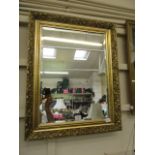 A gilt framed bevel glass wall mirror