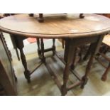 A mid-20th century oak oval gateleg table