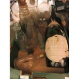 A tray containing a large champagne bottle, whiskey bottle,