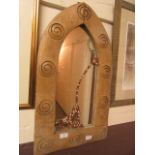 A modern wooden arch-topped wall mirror