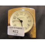 A Swiss made brass travelling clock having Tiffany & Co to dial