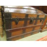 A metal banded dome top travelling trunk