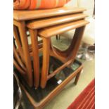 A nest of three mid-20th century teak occasional tables