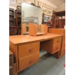 A mid-20th century oak dressing table with mirror to back and small book shelf