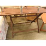 A stained folding wooden garden table