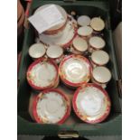 A tray containing a part tea set with red and gilt decoration to include cups, saucers,
