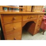 A stained pine twin pedestal desk