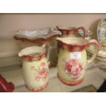A collection of early 20th century ceramic ware to include three pouring jugs,