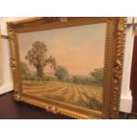 A gilt framed oil on canvas of country scene of man with sheep