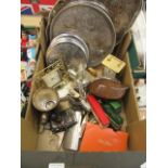 A tray containing plated ware to include trays, casters, old clocks, buses,