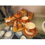A collection of cottage ware to include teapot, butter dish, sugar bowl, cups, saucers,