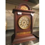 A walnut cased mantle clock